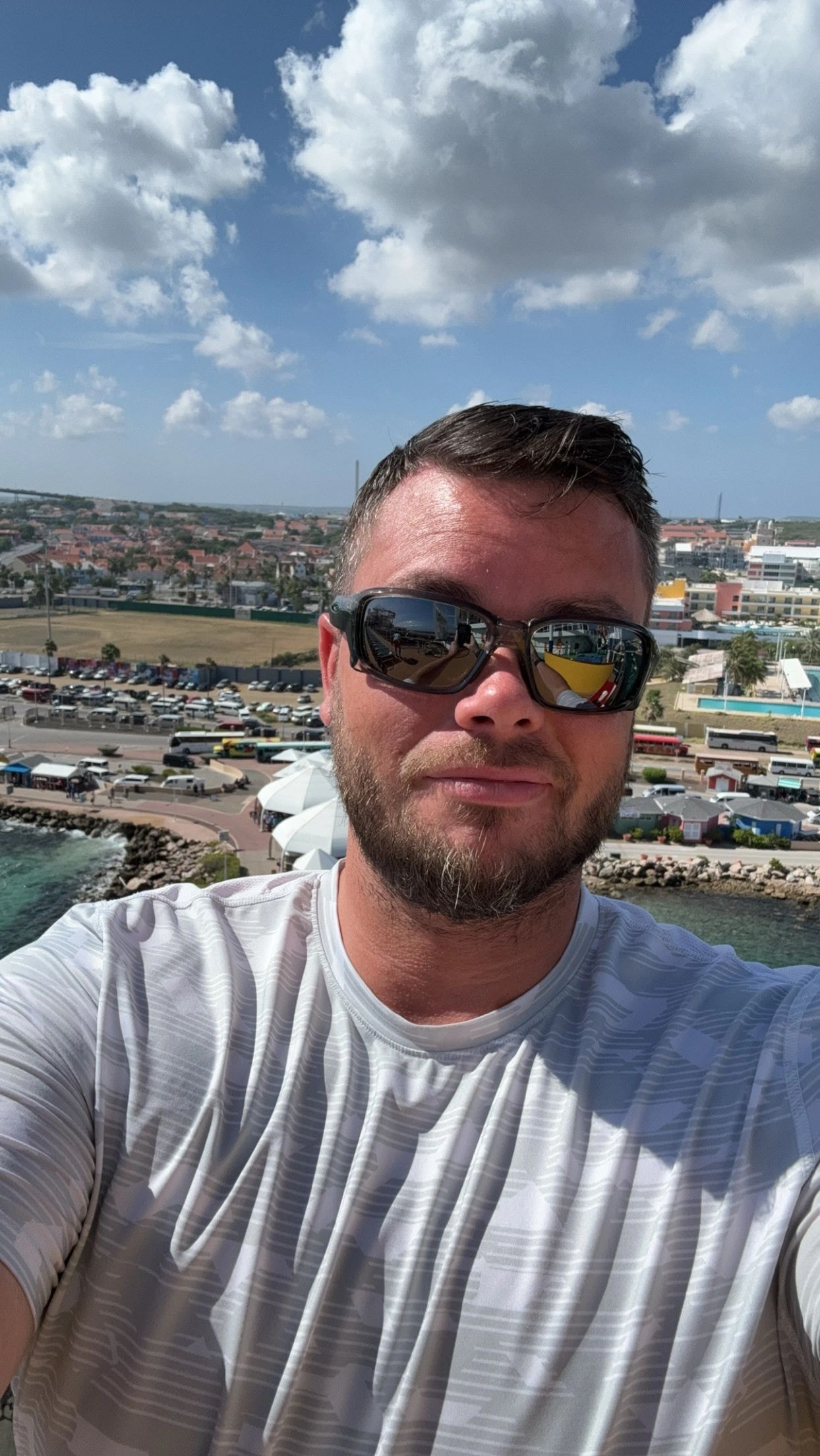 Craig overlooking a coastal town from a cruise ship deck