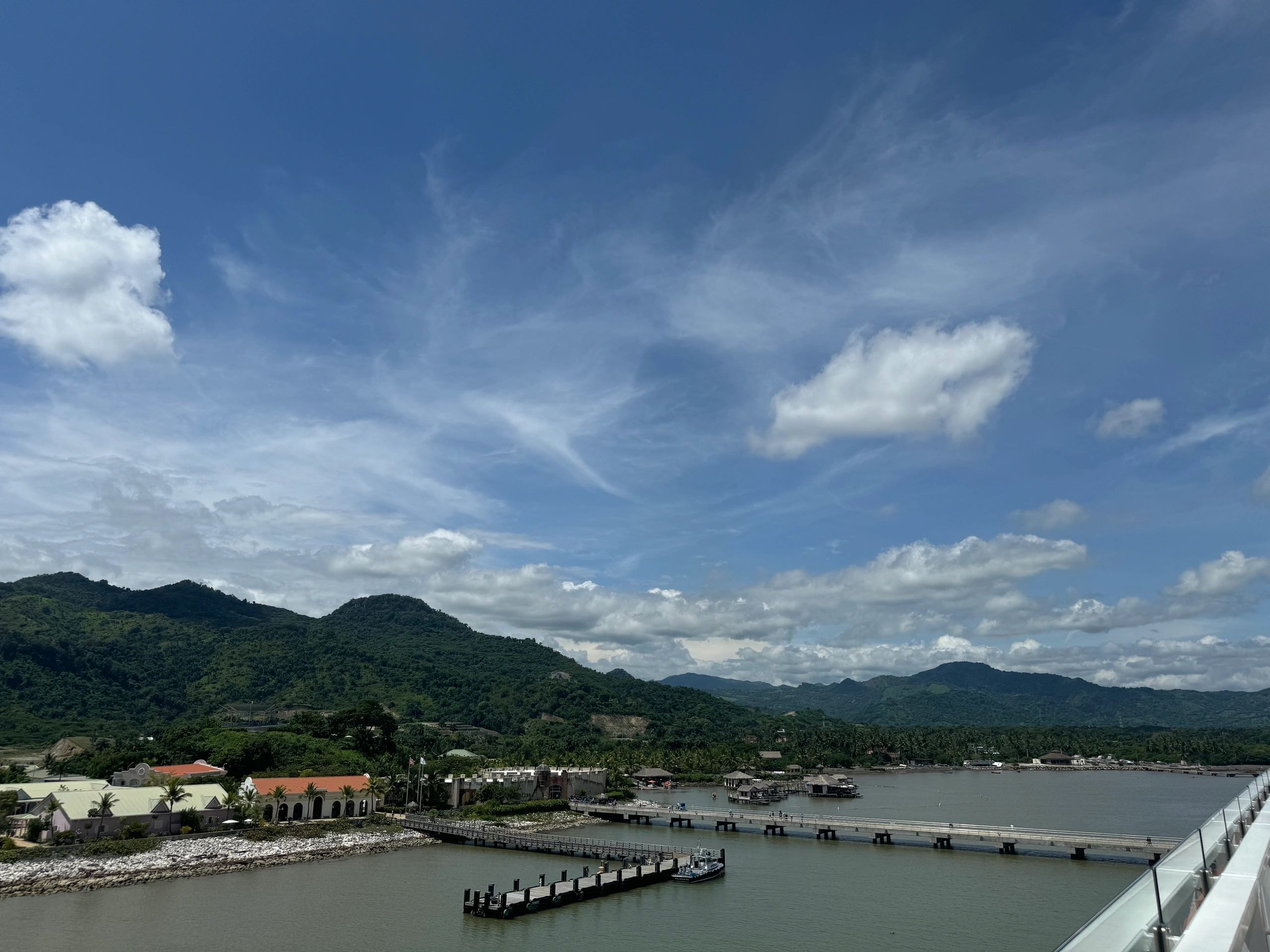 Tropical river port with forested mountains